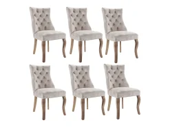 Conjunto de 6 sillas de terciopelo beige claro con patas de madera curvadas y botones decorativos.