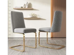 Juego de 4 sillas de comedor en terciopelo gris con respaldo tapizado y patas doradas.