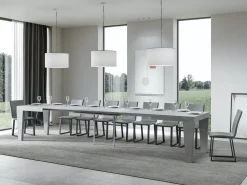 Mesa de comedor extensible de madera Kristo patas en V-Color Gris cemento-Base y soporte con ruedas-5 alargaderas finas-Ancho extensible